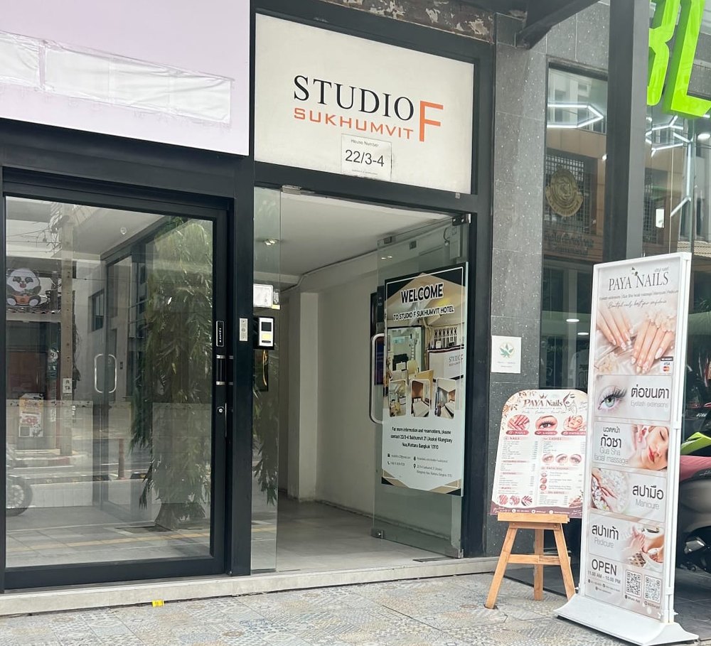 Studio F Sukhumvit entrance on Sukhumvit Soi 21, with the PAYA Nails stand at the door
