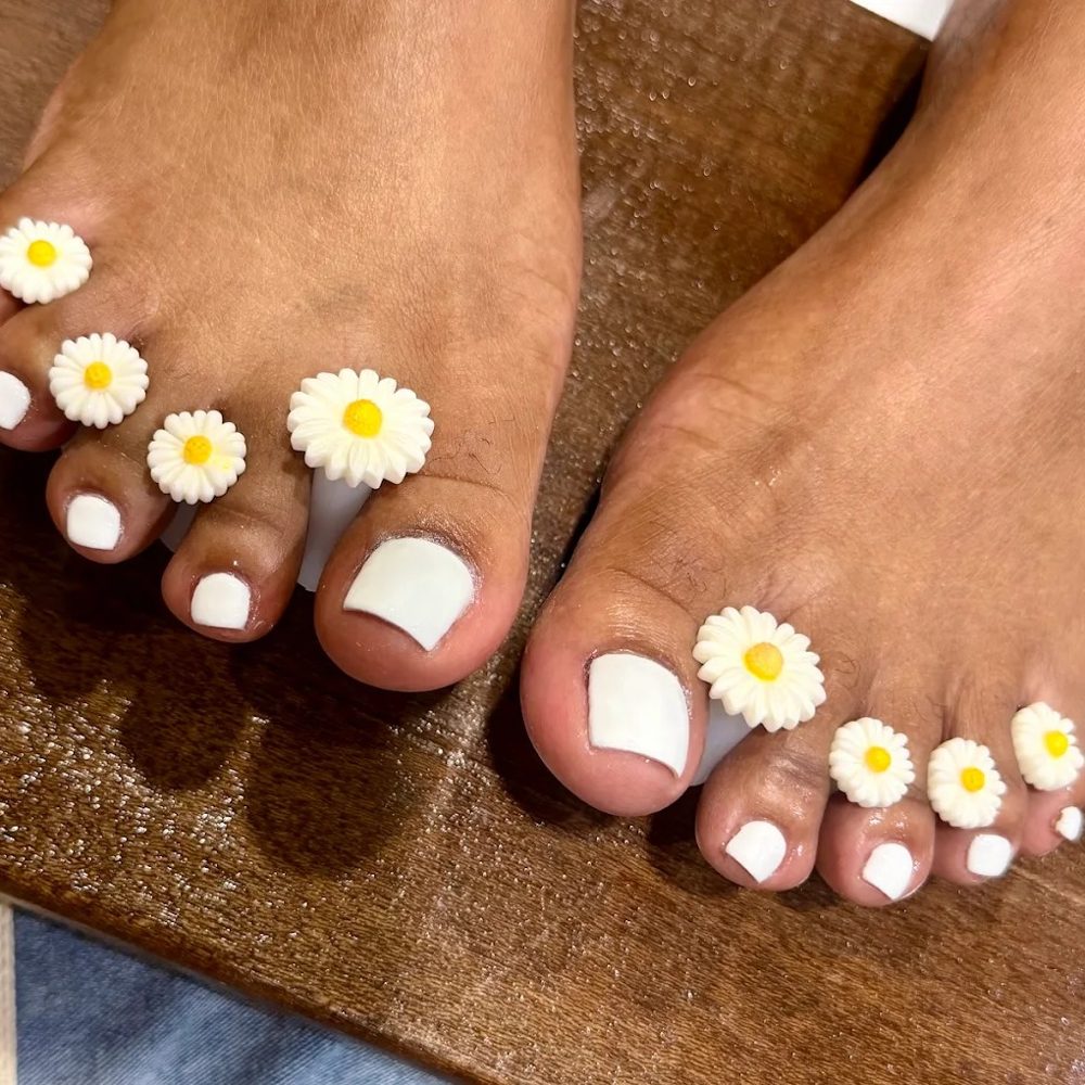 Gel pedicure with white flower art at PAYA, Asok
